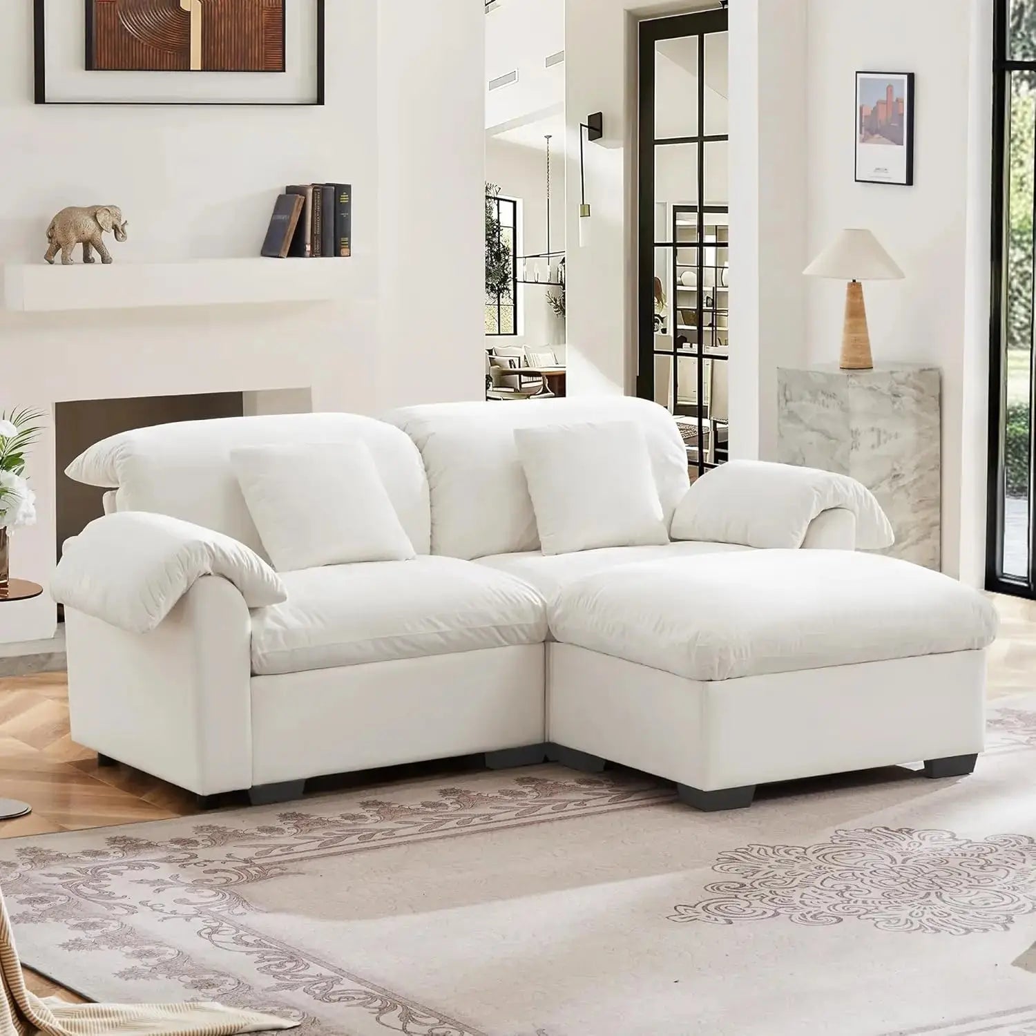 Velvet loveseat sofa with deep seating and storage ottoman in a modern living room. Plush upholstered design offers comfort and style.