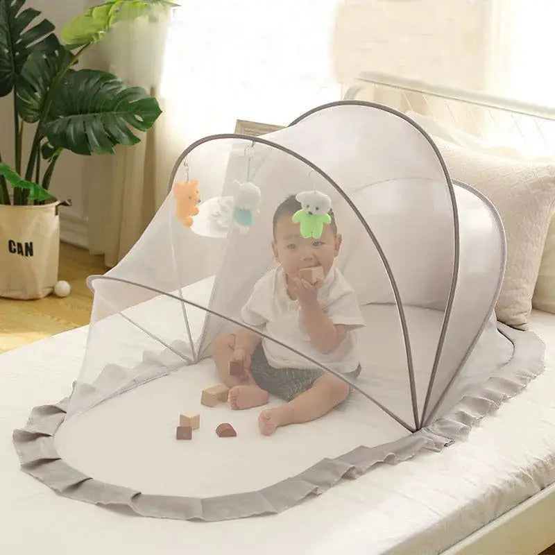 Foldable baby bed with mosquito net and cotton pillows, providing a safe and comfortable sleeping space for infants. Portable design for easy travel.