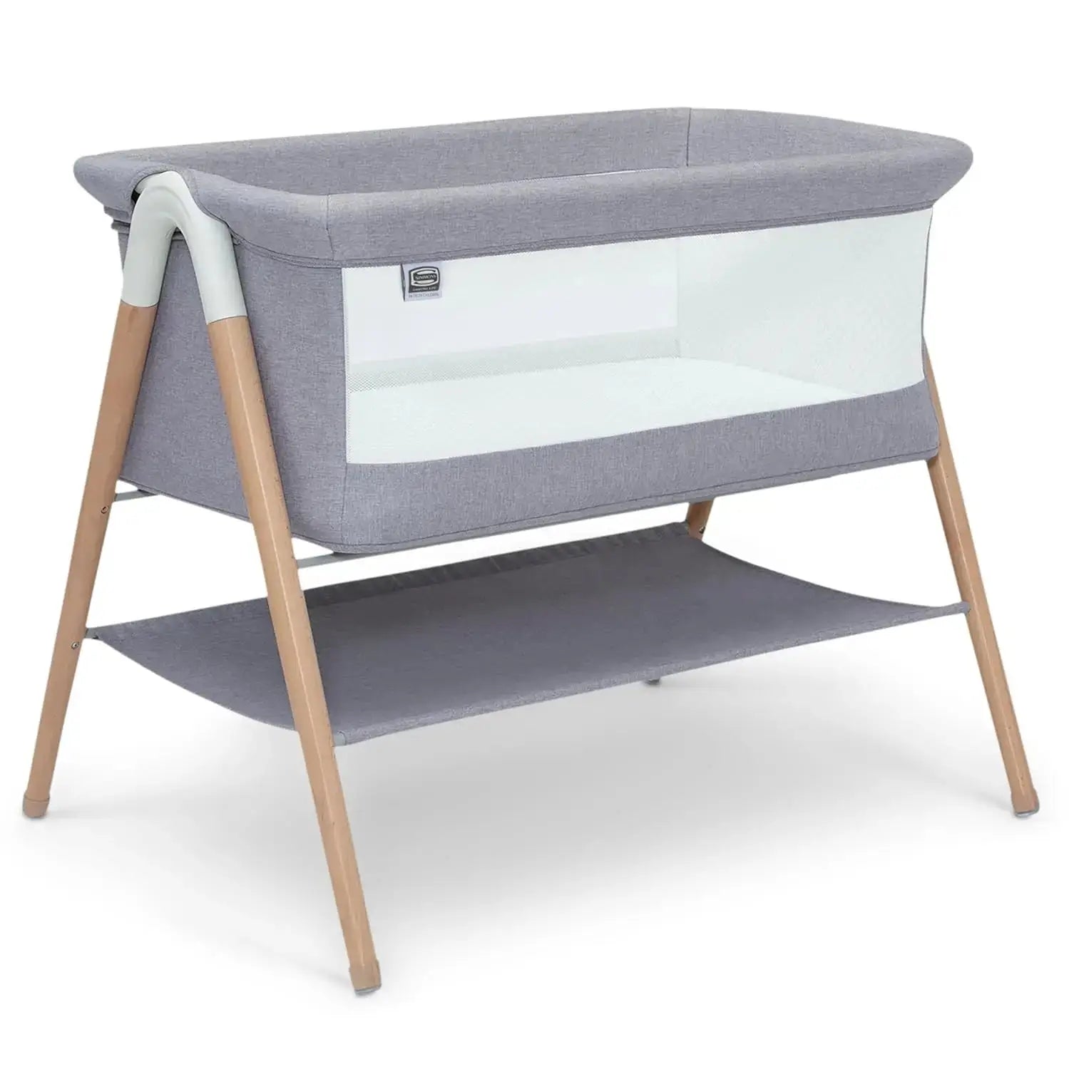 Koi by The Bed Bassinet with breathable mesh sides and natural beechwood legs in dove grey. Features a lower storage shelf, ideal for newborns and parents.