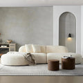 135.4-inch curved sectional sofa upholstered in boucle fabric, featuring a modern design with two matching pillows. Oversized chaise lounge seating for six in a stylish living room setting.