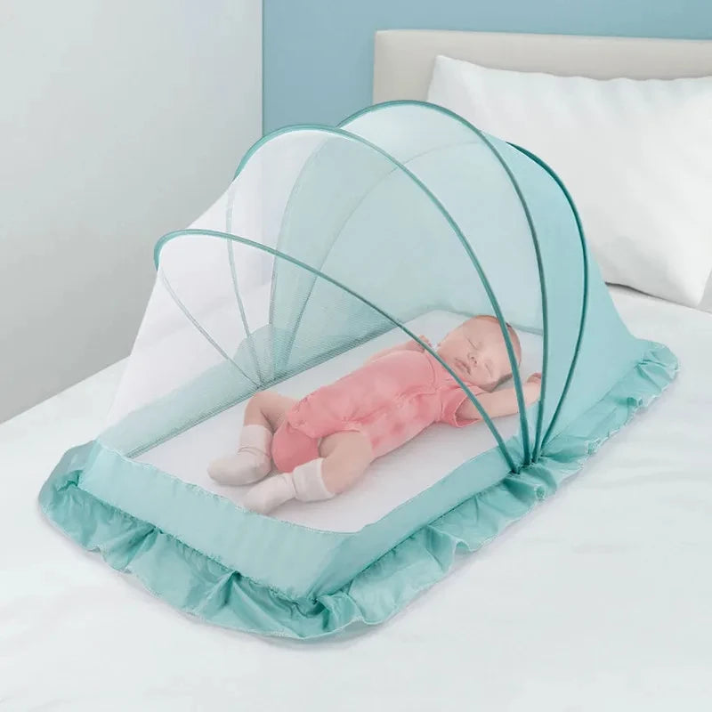 Foldable baby bed with mosquito net and cotton pillows, providing a safe and comfortable sleeping space for infants. Portable design for easy travel.