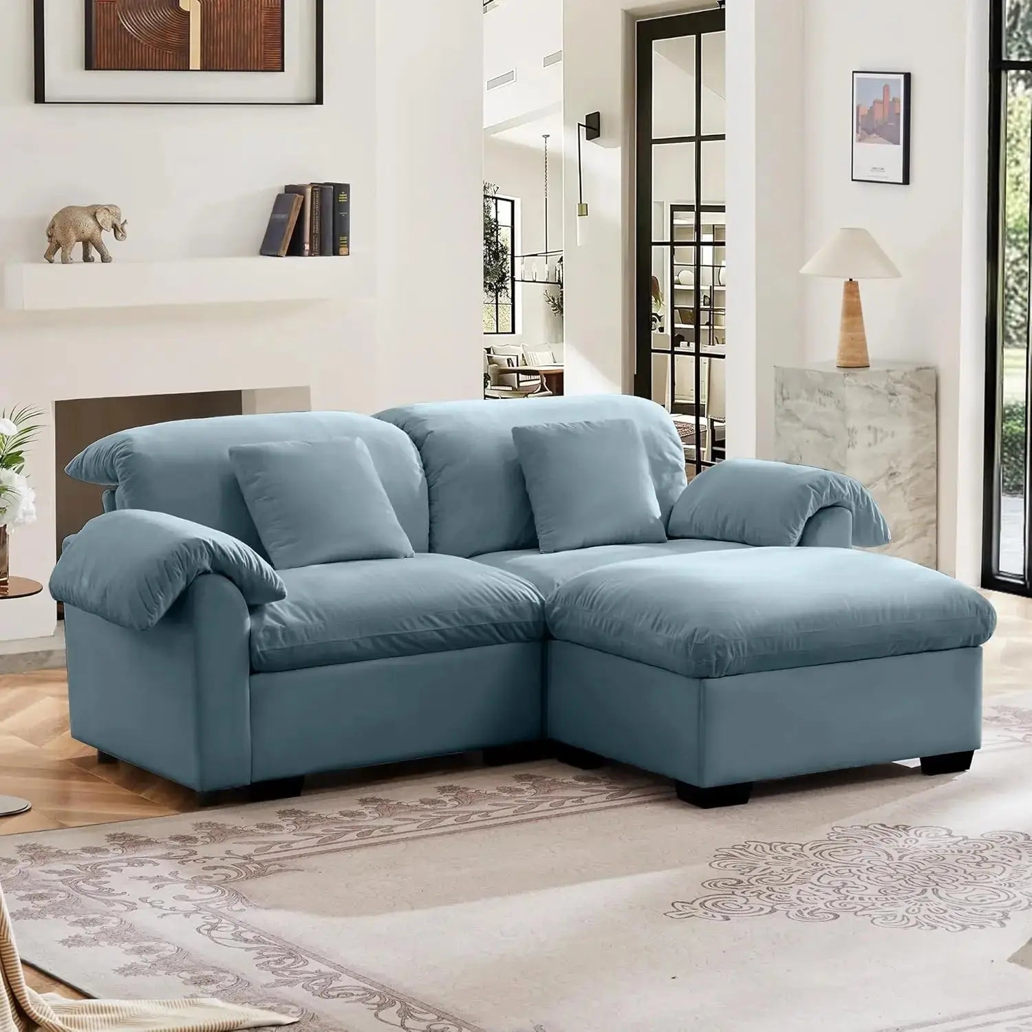 Velvet loveseat sofa with deep seating and storage ottoman in a modern living room. Plush upholstered design offers comfort and style.