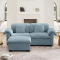 Velvet loveseat sofa with deep seating and storage ottoman in a modern living room. Plush upholstered design offers comfort and style.