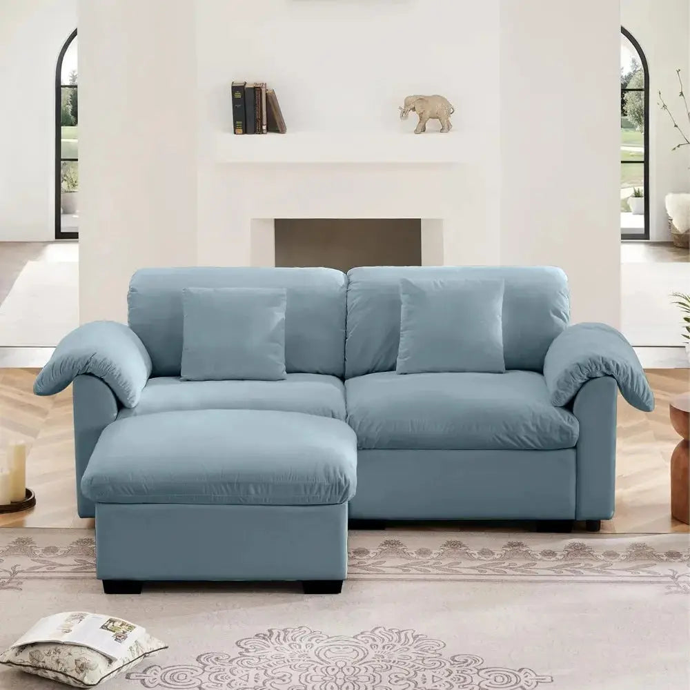 Velvet loveseat sofa with deep seating and storage ottoman in a modern living room. Plush upholstered design offers comfort and style.
