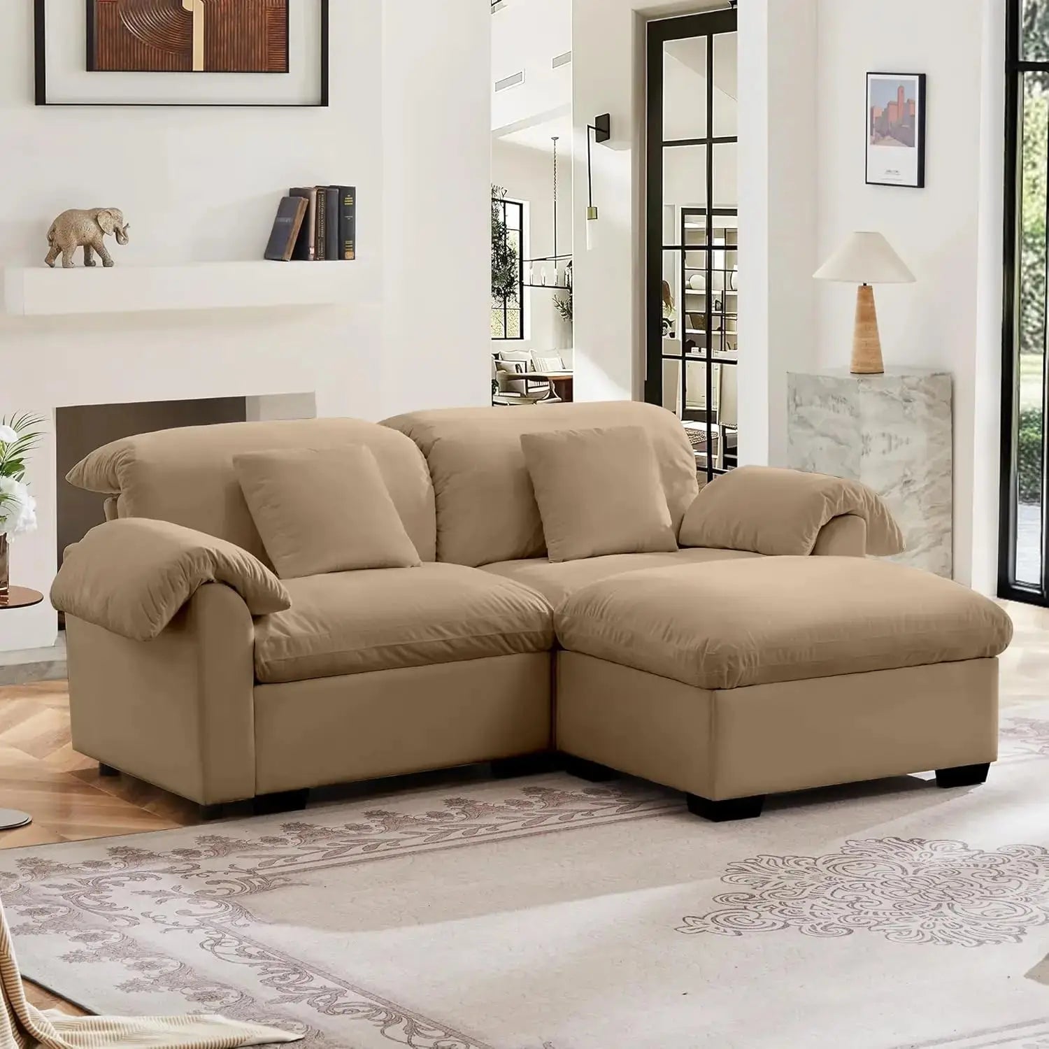 Velvet loveseat sofa with deep seating and storage ottoman in a modern living room. Plush upholstered design offers comfort and style.