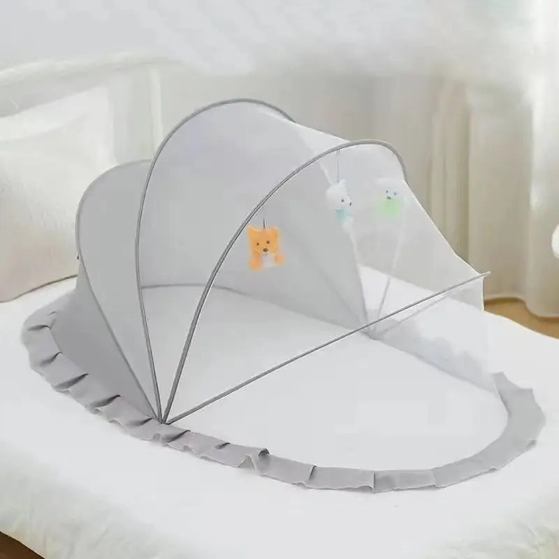 Foldable baby bed with mosquito net and cotton pillows, providing a safe and comfortable sleeping space for infants. Portable design for easy travel.