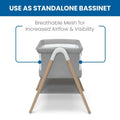 Koi by The Bed Bassinet with breathable mesh sides and natural beechwood legs in dove grey. Features a lower storage shelf, ideal for newborns and parents.