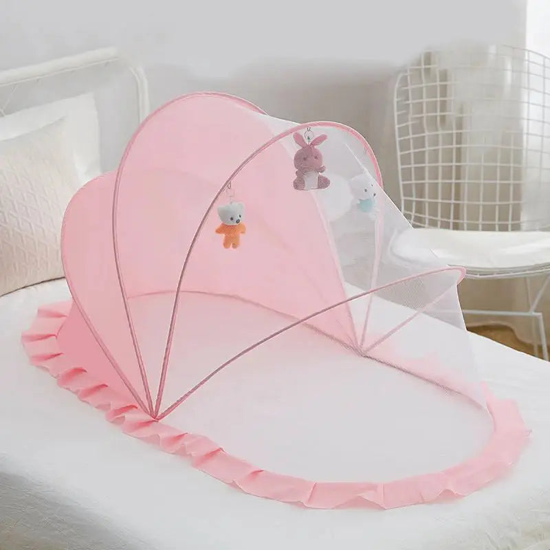 Foldable baby bed with mosquito net and cotton pillows, providing a safe and comfortable sleeping space for infants. Portable design for easy travel.