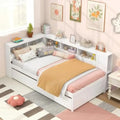 Twin daybed with trundle and storage in a cozy bedroom. Features a reversible bookcase headboard, wooden slats, and bedside shelves for organization.