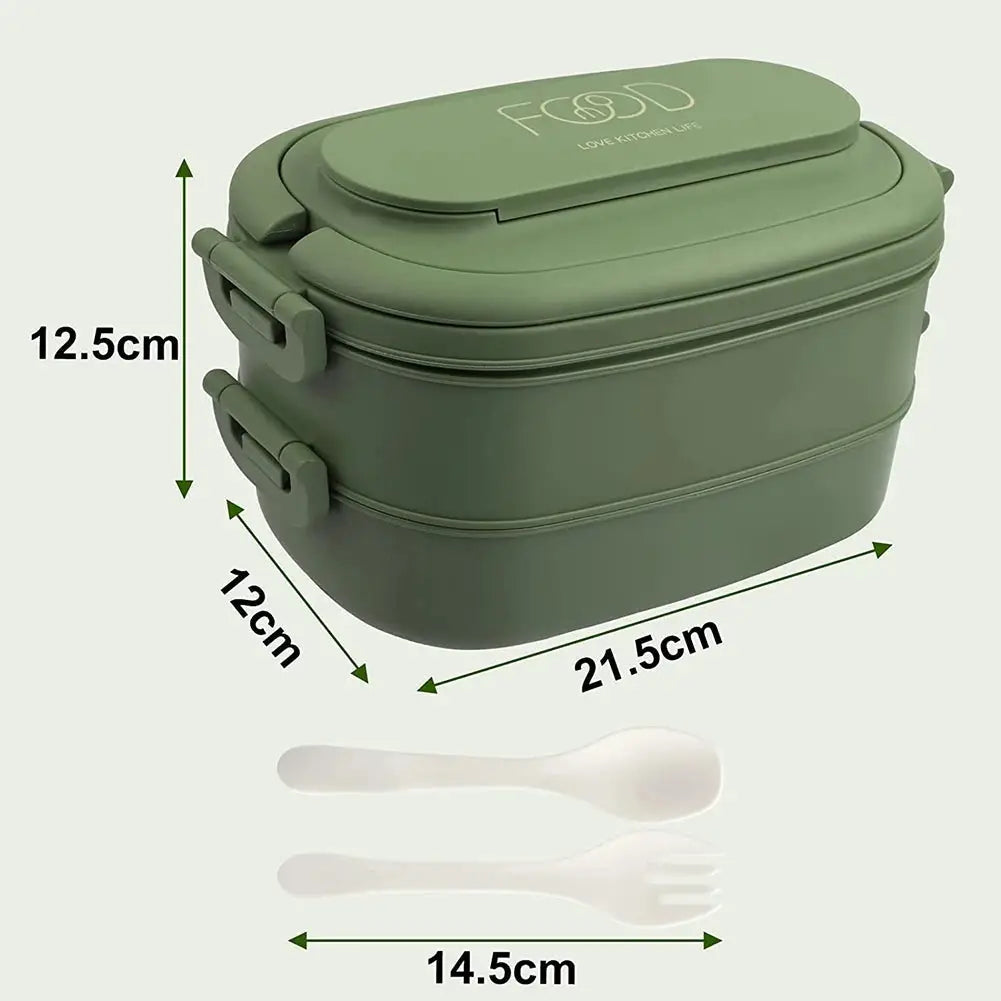 Green leakproof bento lunch box with cutlery set for kids and adults, placed on a kitchen counter. Durable, non-toxic, and safe for daily use.