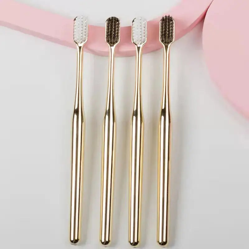 Four luxury gold toothbrushes with soft bristles in different shades. High-end electroplate gold design for wholesale customization.