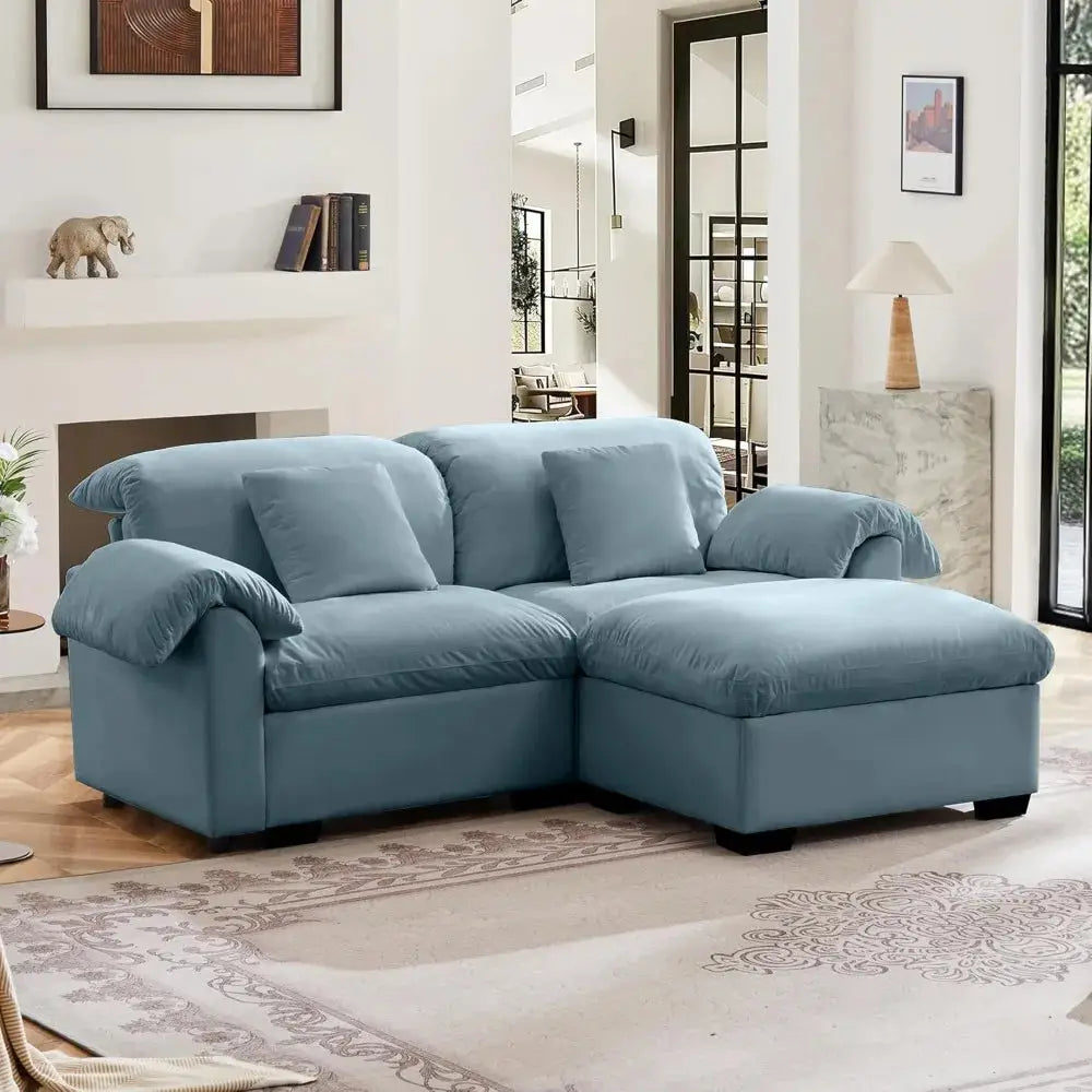 Velvet loveseat sofa with deep seating and storage ottoman in a modern living room. Plush upholstered design offers comfort and style.