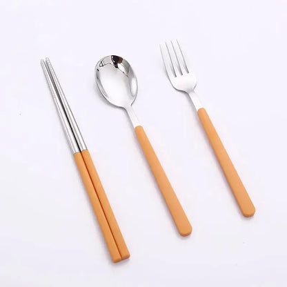 Stainless steel travel cutlery set in compact cases. Portable and reusable silverware with spoon, fork, and chopsticks, ideal for picnics or travel.